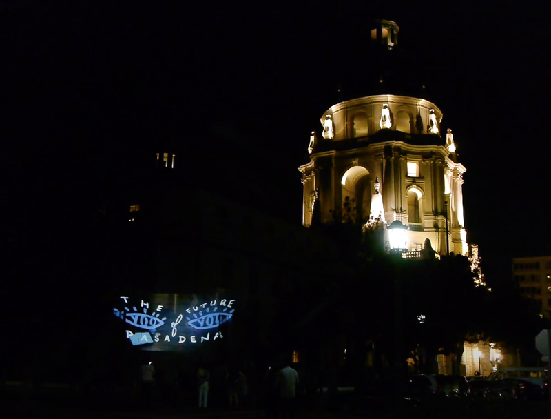 The dome of Pasadena City Hall lit up at night with projections.